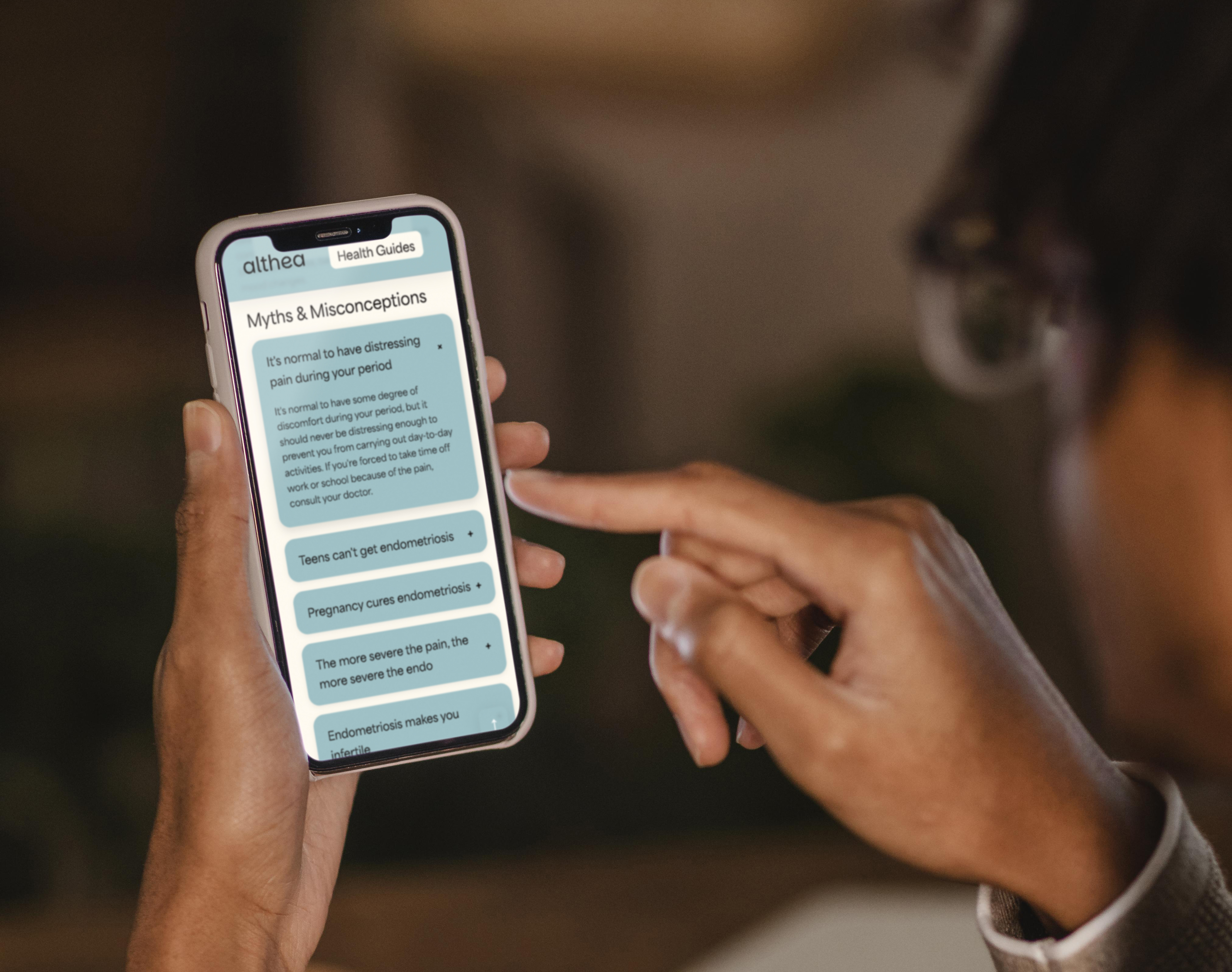 person holding phone mockup of Althea myths and misconceptions