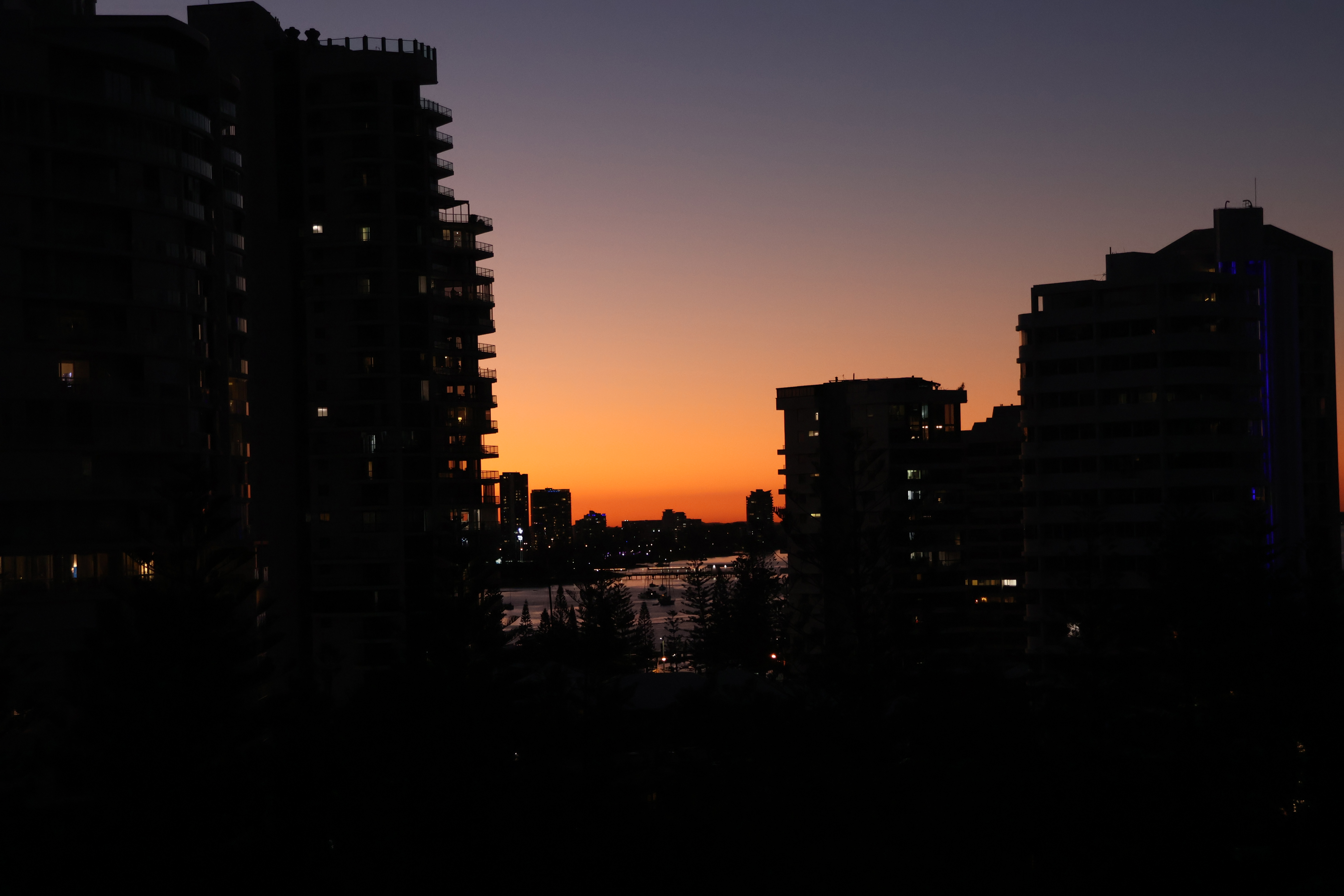 sun setting behind skyline