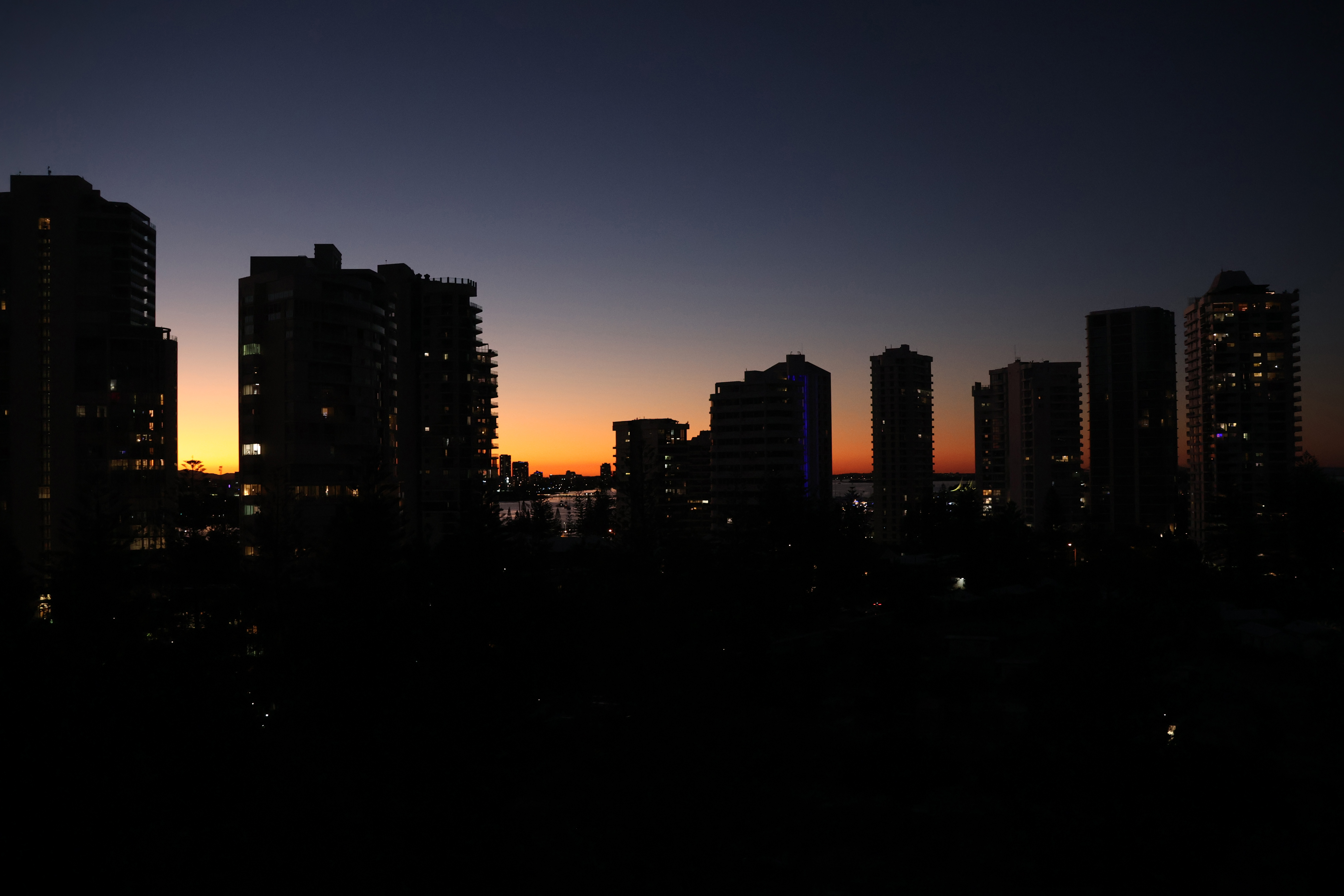 sun setting behind skyline