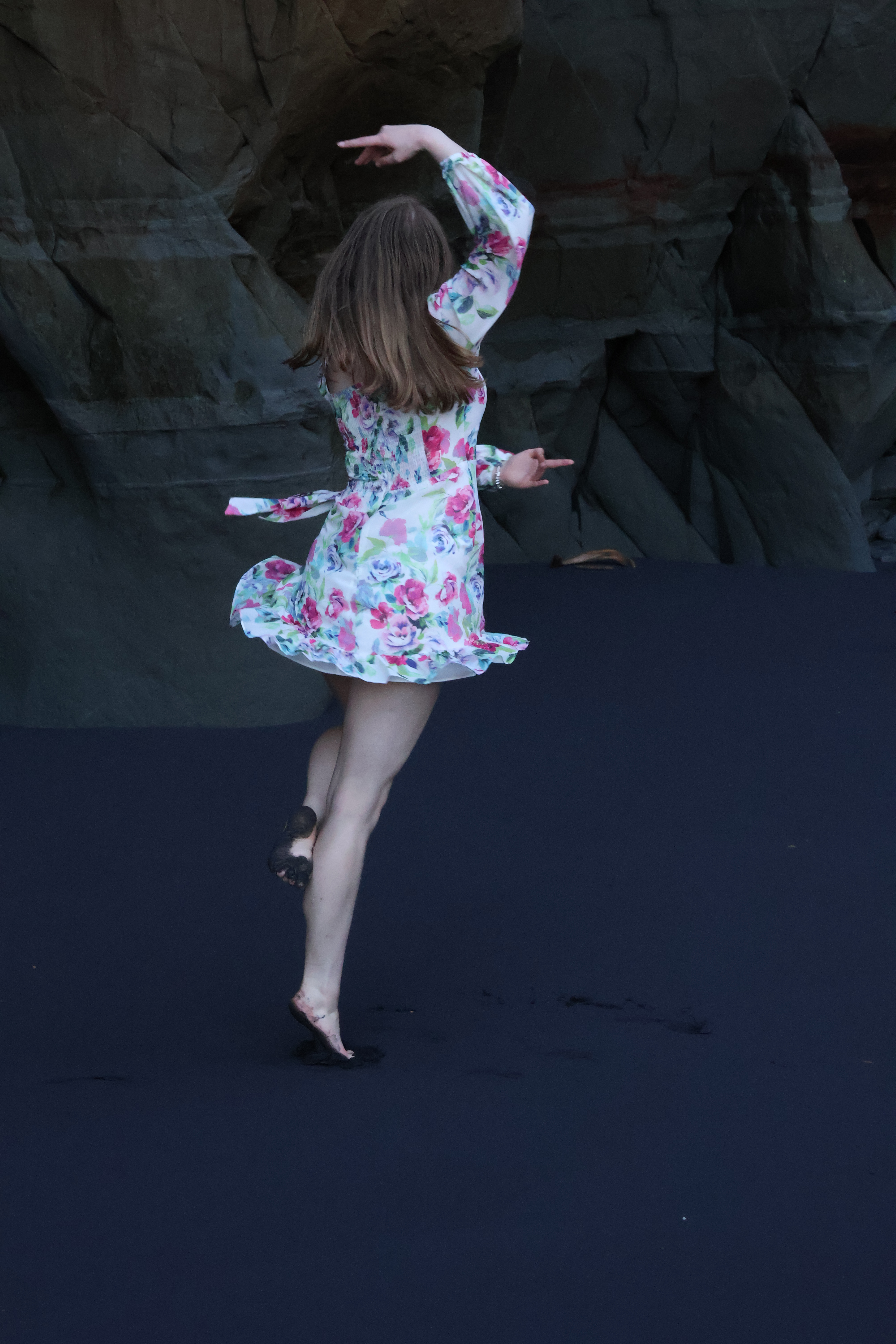 girl twirling on beach