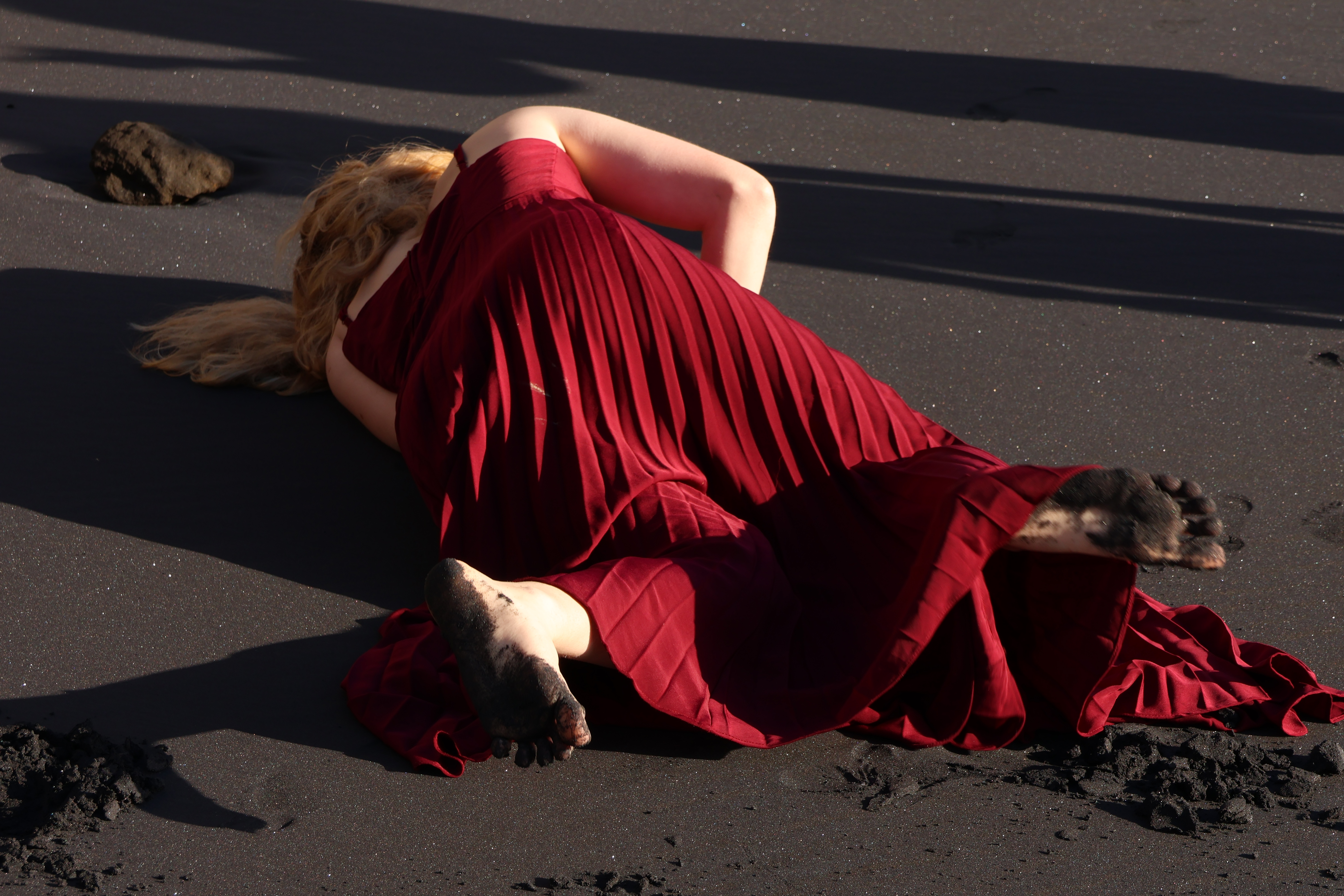 person laying in the sand laughing